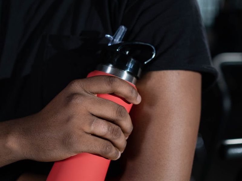 Close-up of fitness equipment and a bottle of water.